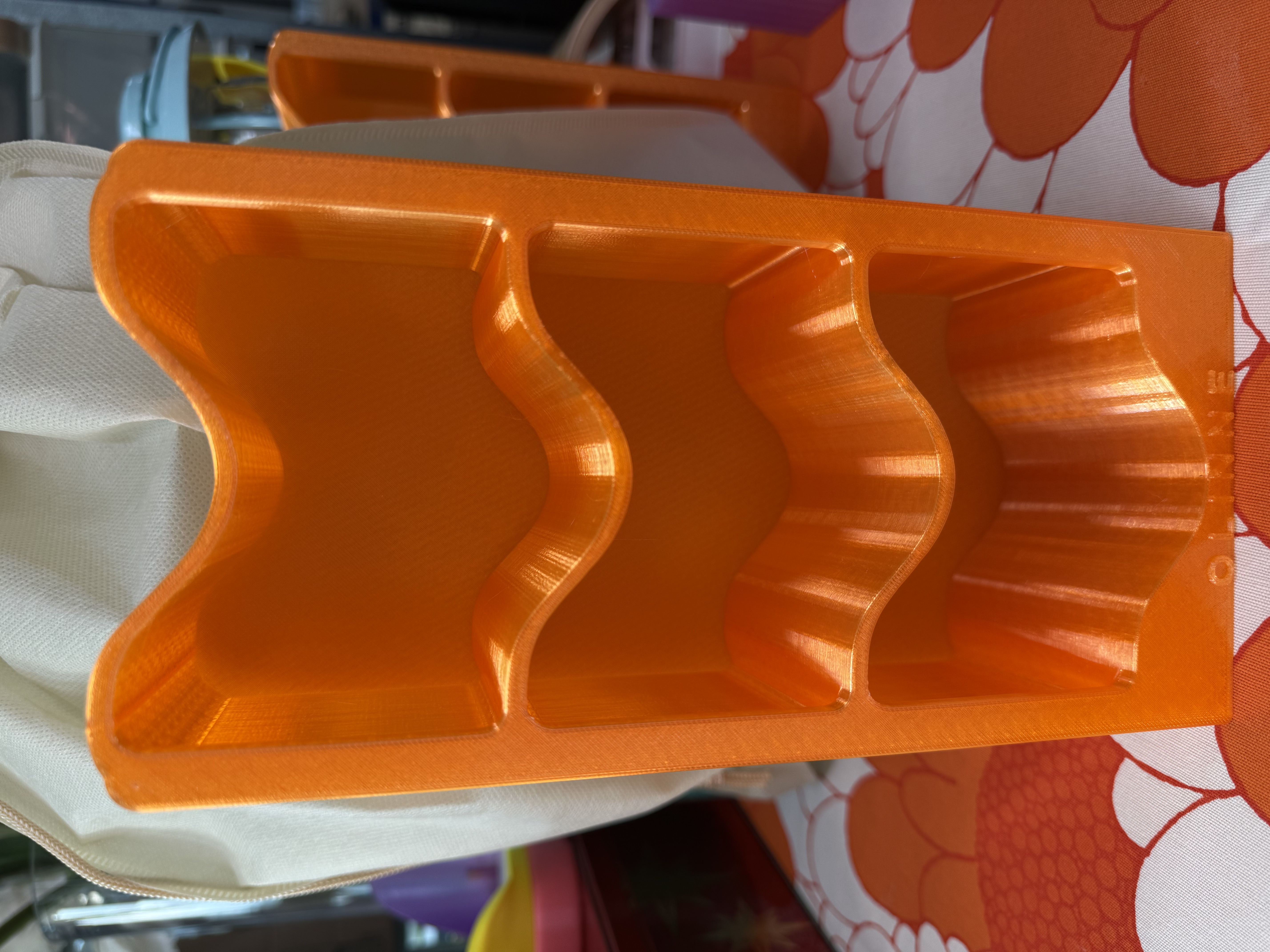 Orange OLINNE Swim Closet showing the three wave-shaped compartments and 3D-printed texture