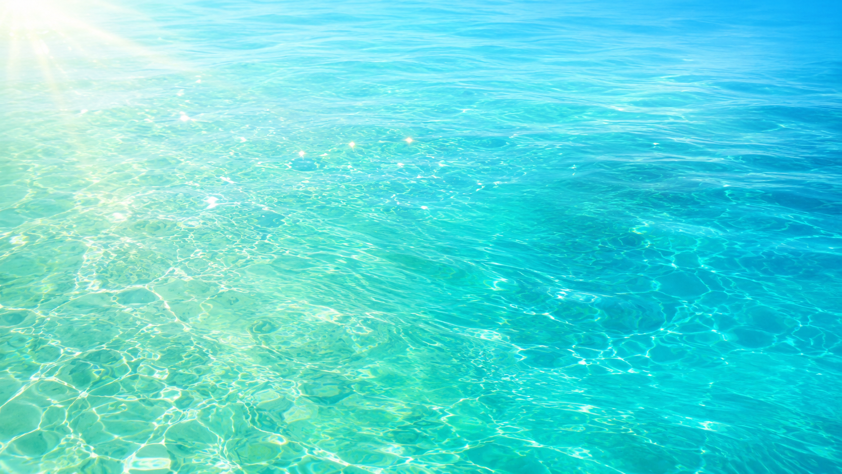 Sunlight shimmering across clear turquoise water